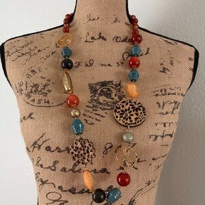 Joan Rivers
Large multi colored Beaded Necklace w/ wood & gold accents.